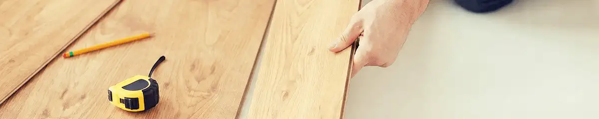 A professional installing wood flooring in Toledo, OH