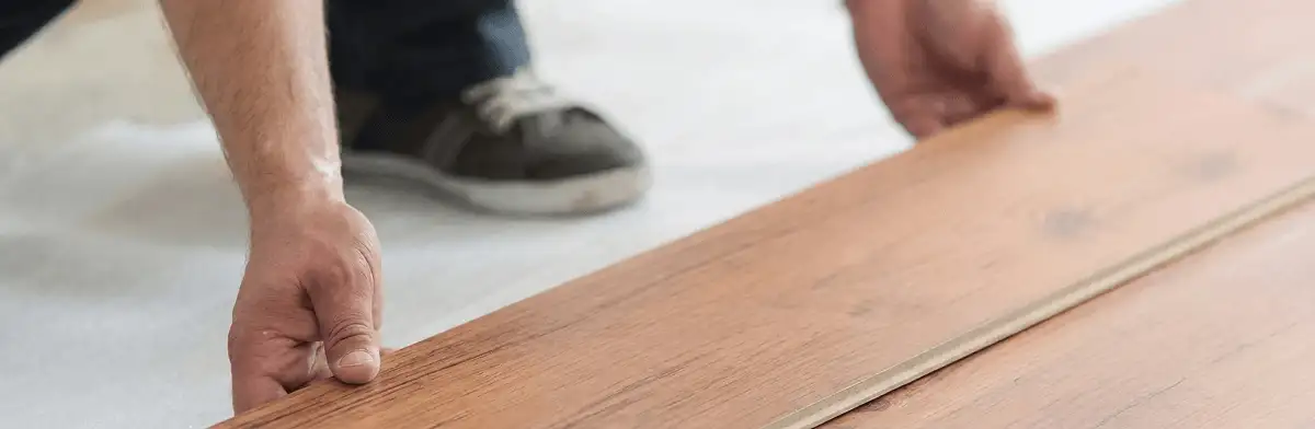 A professional installing laminate flooring in Toledo, OH